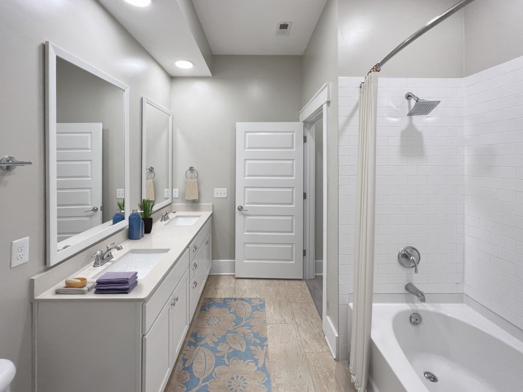 Luxury apartment bathroom with large shower and double vanity sink