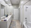 Luxury apartment bathroom with large shower and double vanity sink