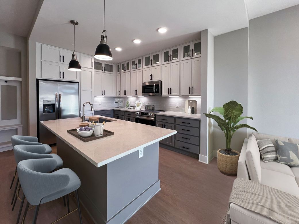 Carraway Village kitchen with island, stainless steel appliances, and custom cabinets