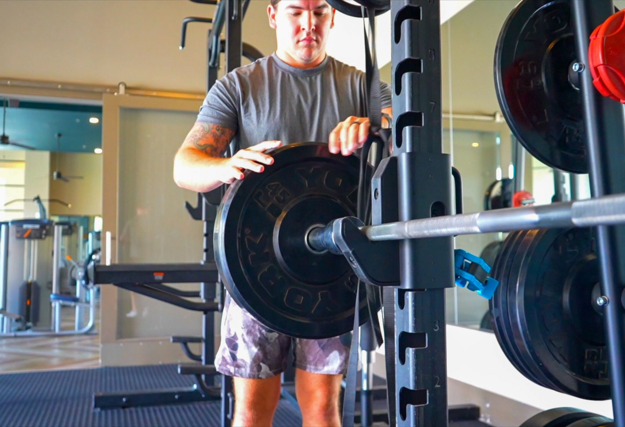 Cardio equipment including ellipticals, stair steppers, and treadmills inside large apartment fitness center